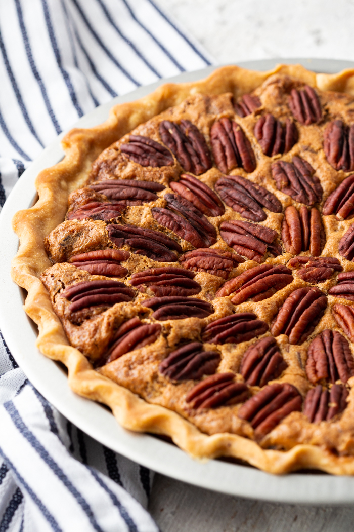 Easy, delicious, pecan pie, with a striped napkin next to it