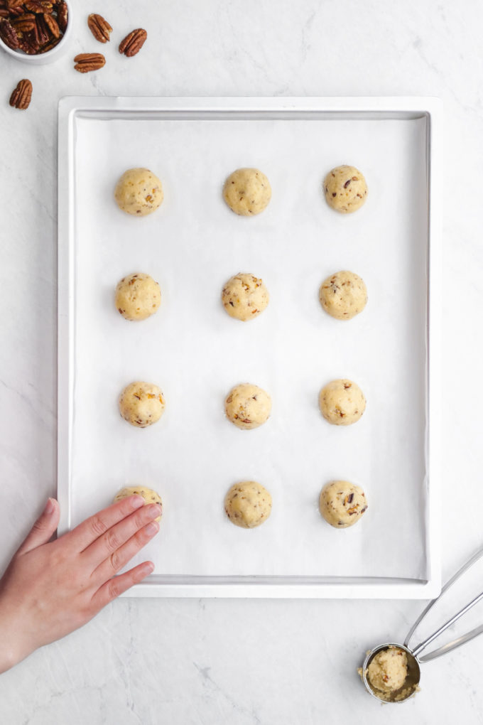 Pressing down the pecan sandies dough