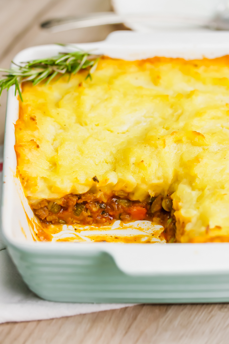 Shepherd's pie in a casserole dish, with the corner scooped out