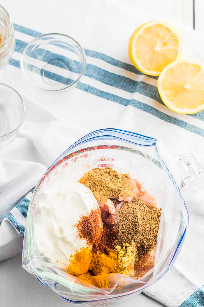 Making a marinade. All the spices and creamy yogurt used to make butter chicken