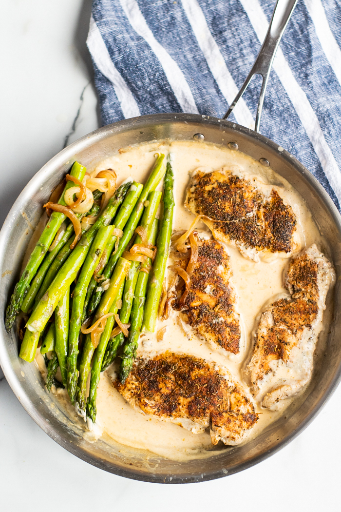 Add your asparagus back into the pan for creamy lemon chicken and asparagus