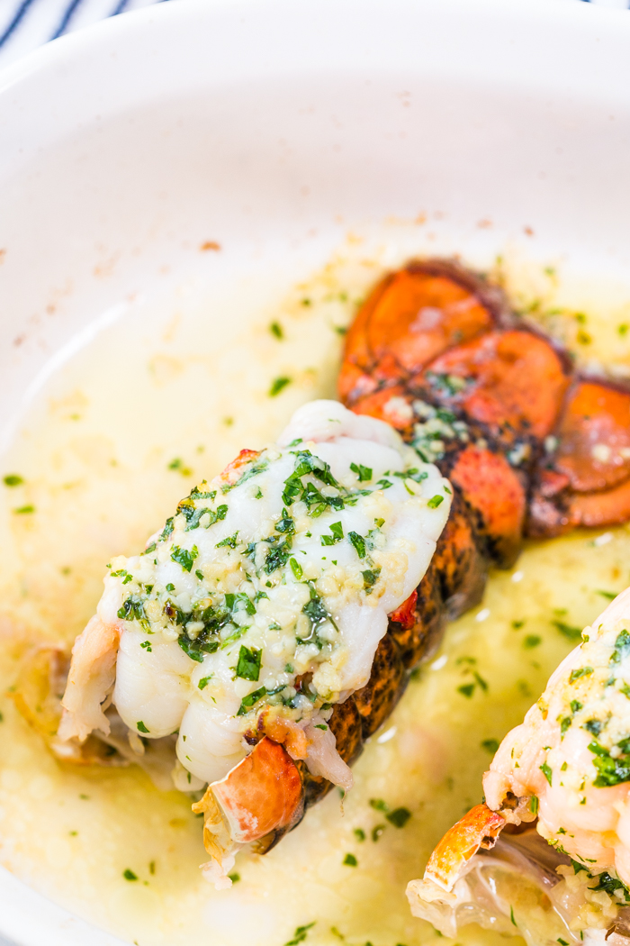 Baked lobster tail with a mixture of garlic butter and herbs