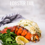 Cooked lobster tail on a white plate with parsley and lemon wedge, with the words How to cook lobster tail as an overlay