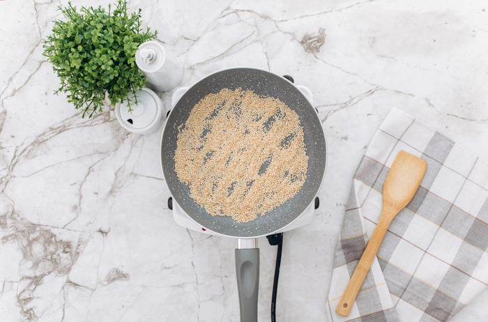 saute pan with spices in it and wood spatula