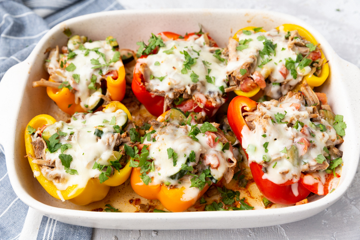 Pork stuffed peppers, topped with cilantro and sweet and smokey pork