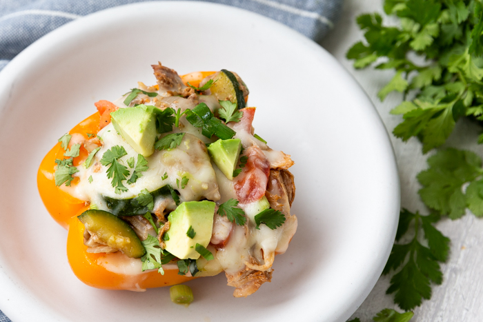 A white plate with a stuffed pepper on top