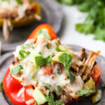 A plate with a close up of a pork stuffed peppers