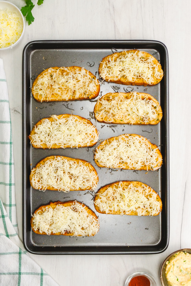How to make garlic bread, several pieces of garlic bread on a baking sheet