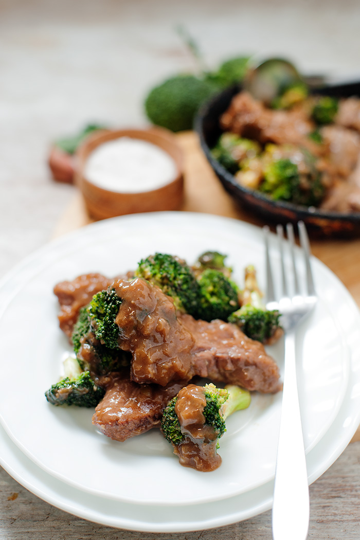 birds eye view of white plate and fork keto beef and broccoli