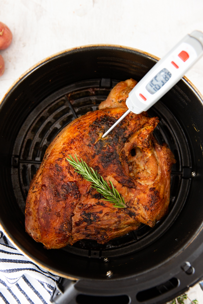 Cook turkey breast in the air fryer basket with a meat thermometer reading 165 degrees. 