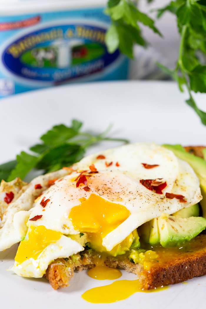 Avocado toast with a fried egg and chili pepper flakes