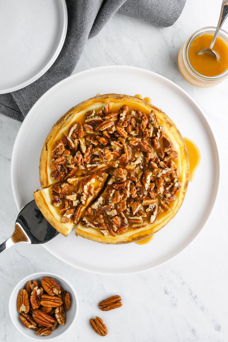 A top down shot of the instant pot cheesecake with a caramel pecan topping