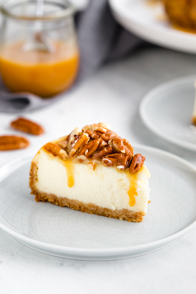 Caramel pecan instant pot cheesecake slice on a white plate