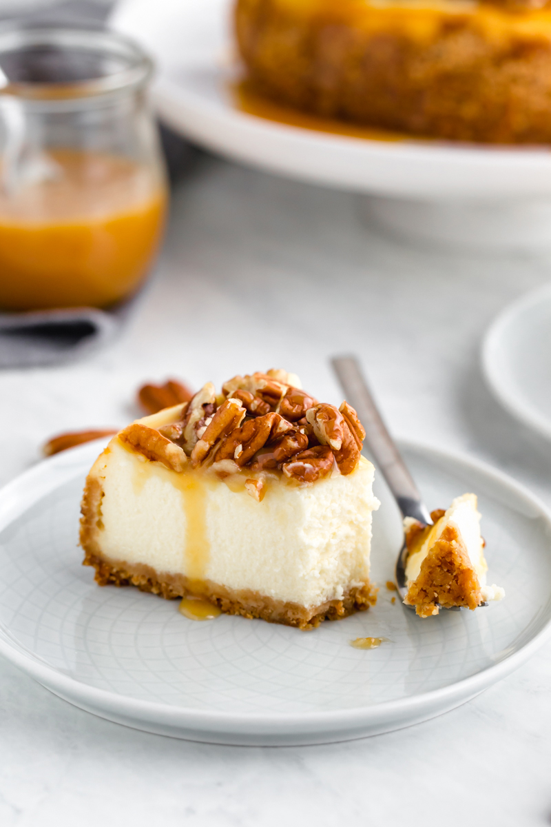 A piece of cheesecake with caramel pecan topping