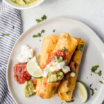 A white plate with breakfast taquitos