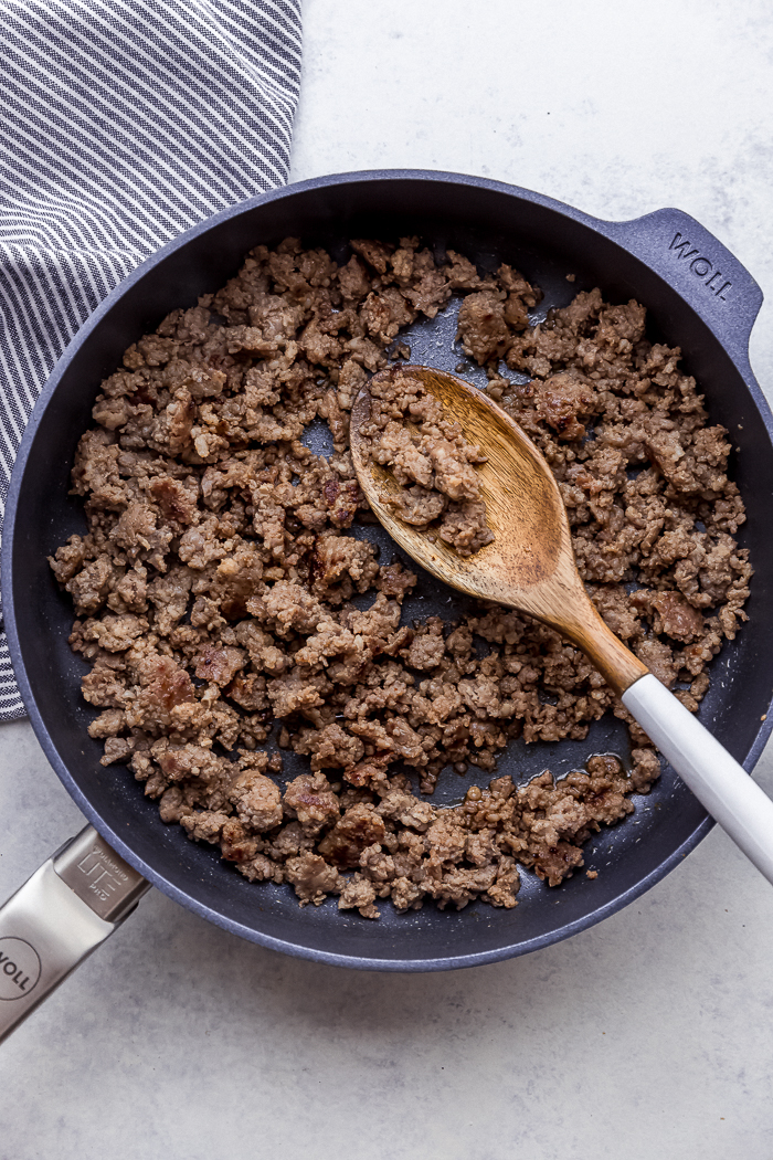 A skillet of browned sausage crumbles