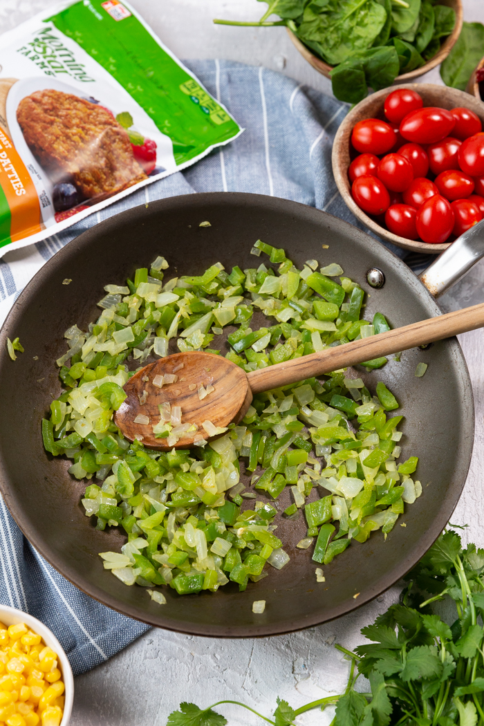 Green peppers and onions in a saute pan