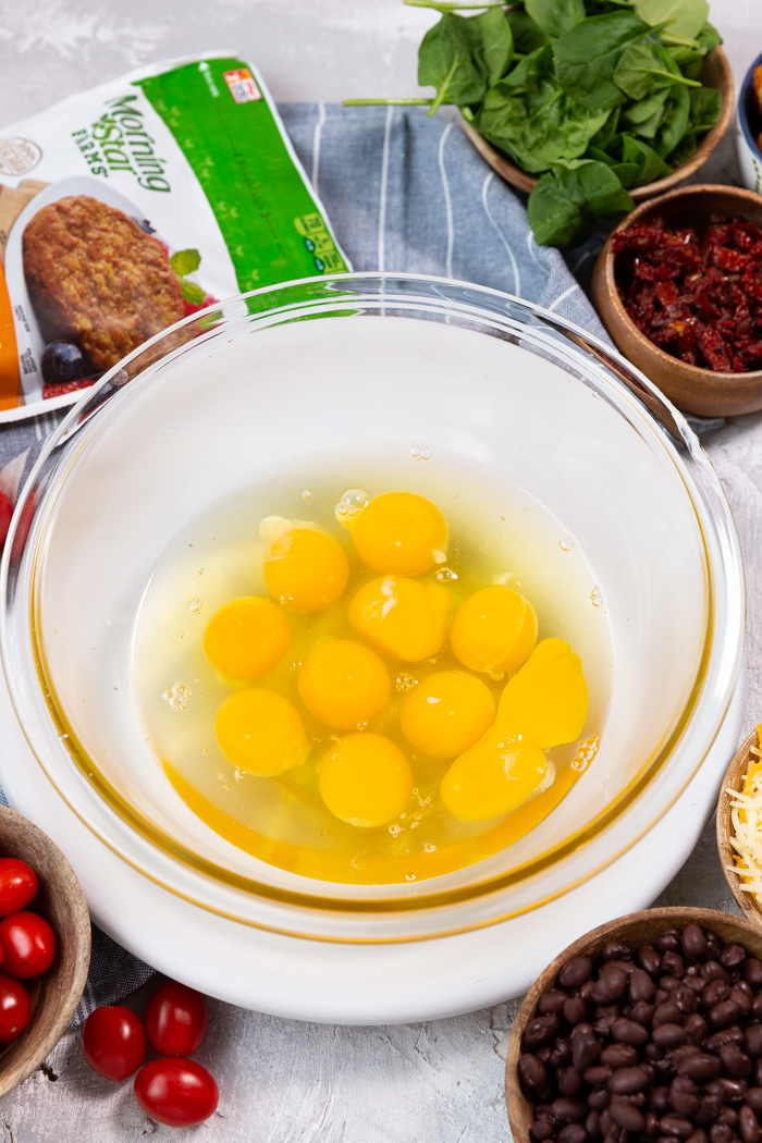 Eggs in a glass bowl for freezer breakfast burritos