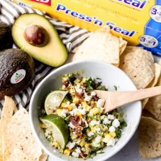 a bowl full of bacon and corn guacamole