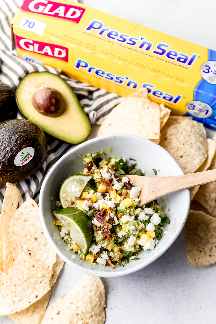 a bowl full of bacon and corn guacamole