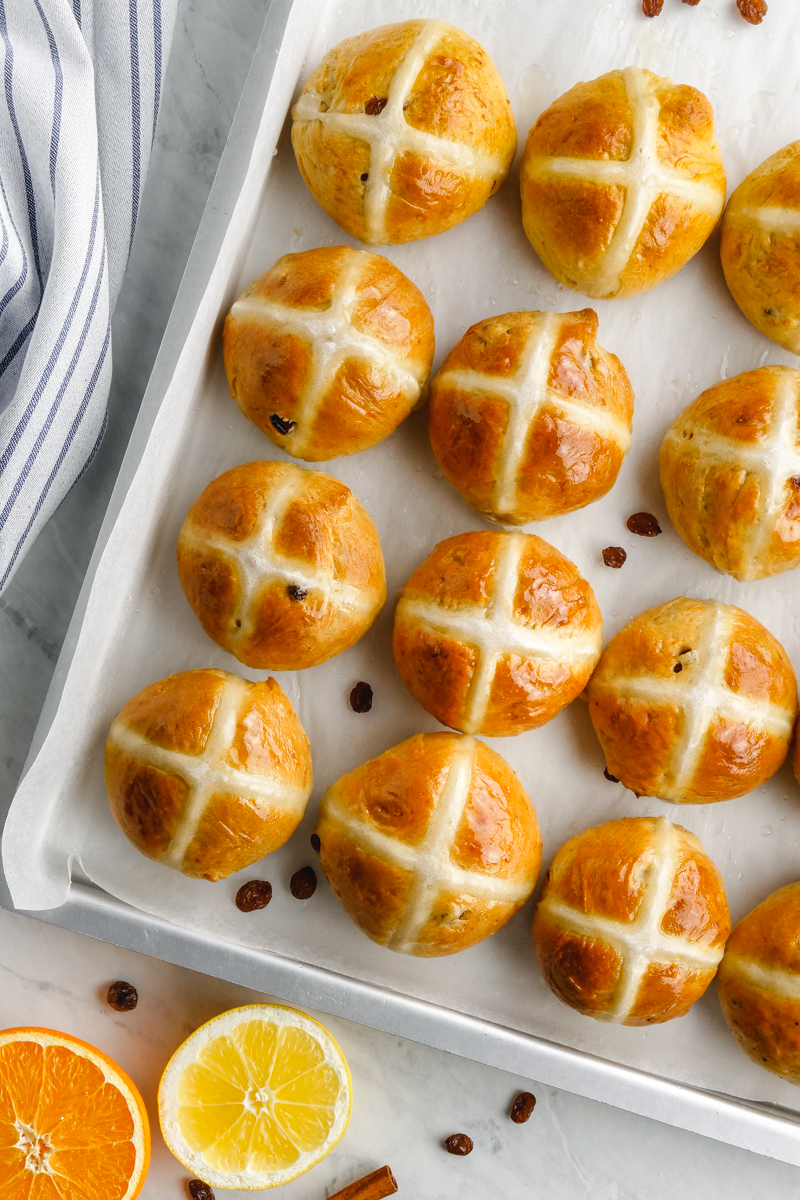 A tray of hot cross buns with fruit and spices