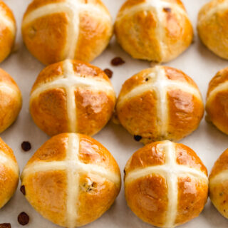 Hot crossed buns on a tray with the traditional cross on top