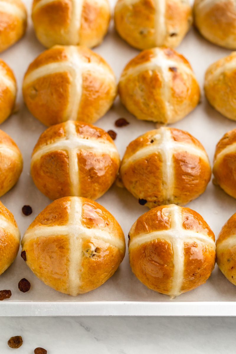 Hot crossed buns on a tray with the traditional cross on top