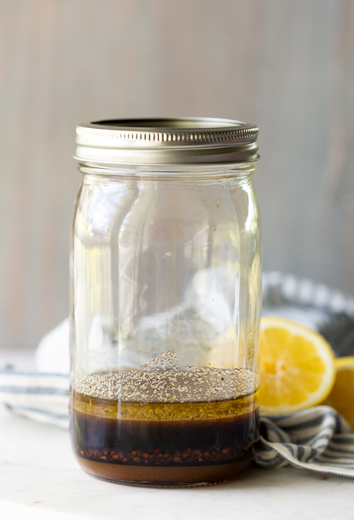 A jar filled with an all purpose marinade for chicken or pork