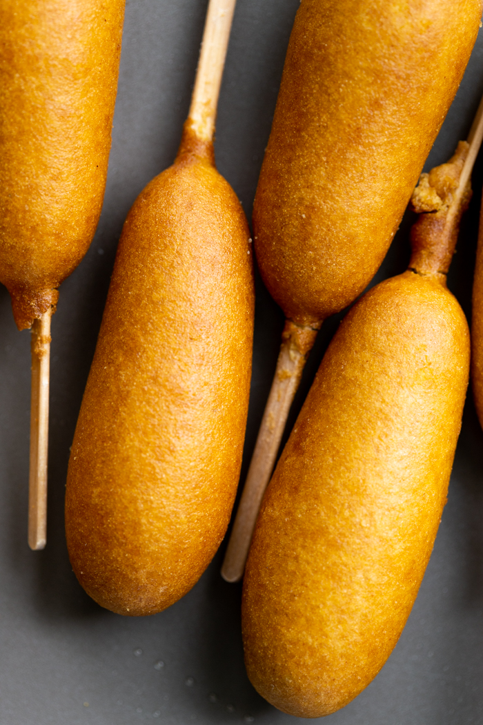 Baked corn dogs on a sheet pan