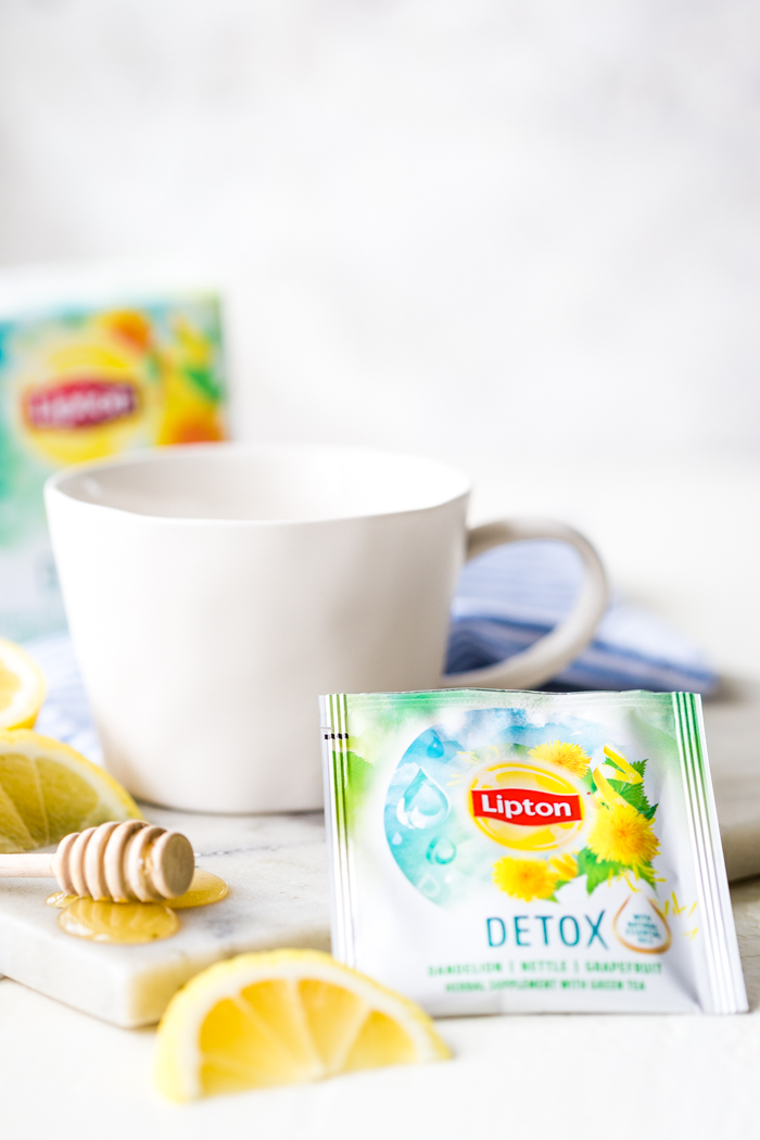 A single serve detox tea with a white mug, lemon slice, and honey