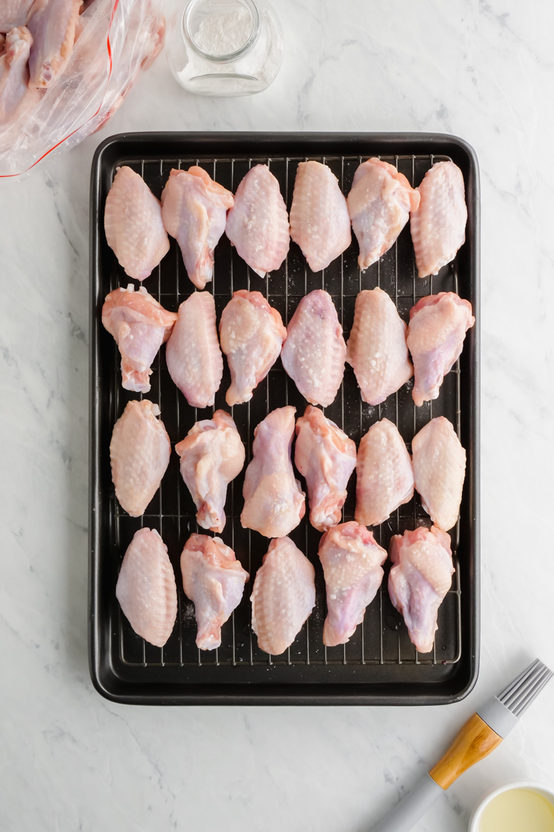 Baking wings on a cooling rack inside a baking sheet