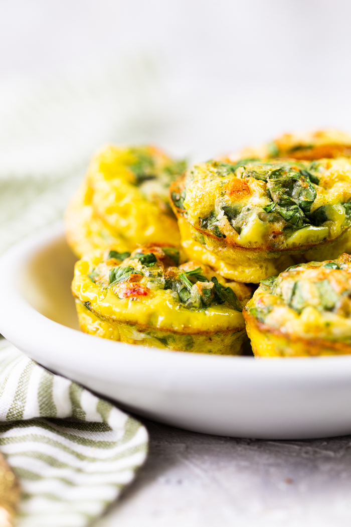 a white plate with sun dried tomato egg muffins