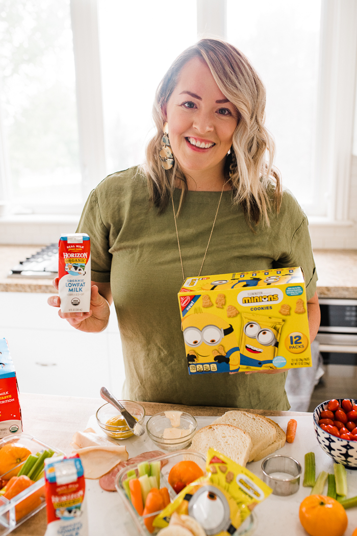 Woman holding horizon milk carton and minion cookies