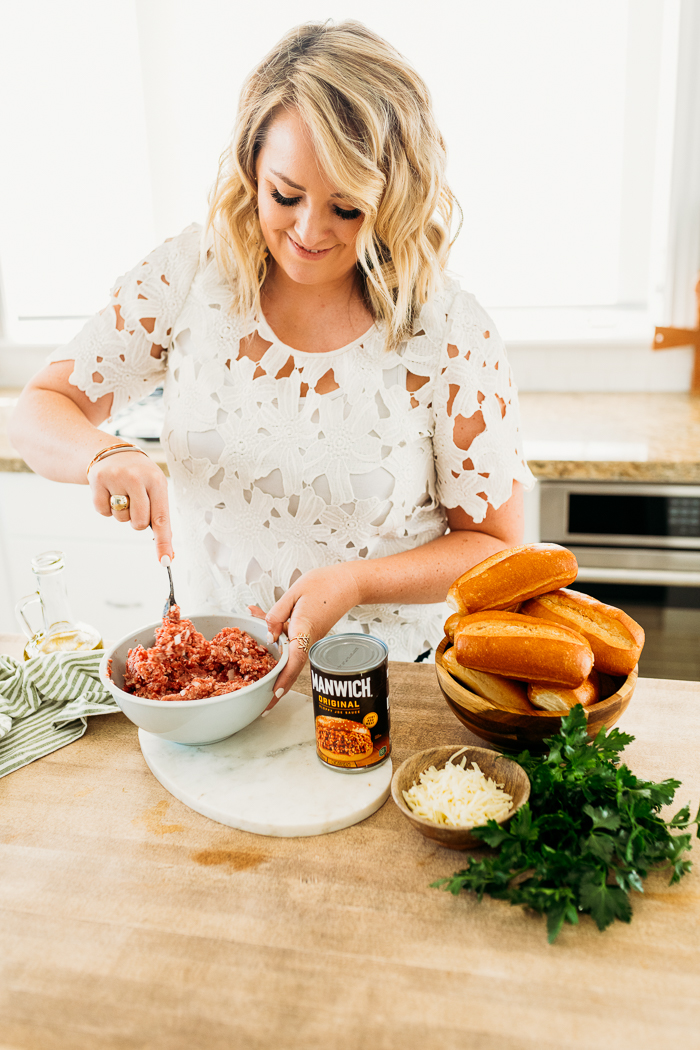 Woman mixing ground meats together in a bowl, with manwich sloppy joe sauce near by