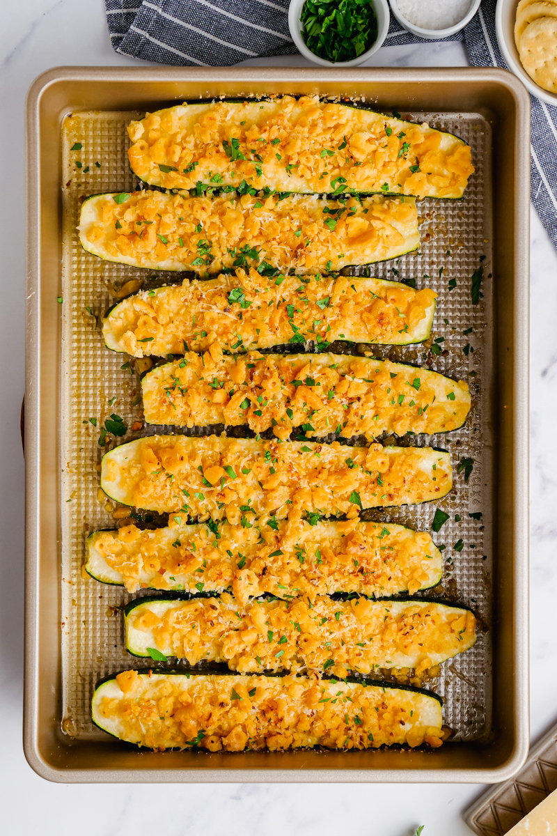 A baking dish filled with halved zucchini topped with a cracker mixture.