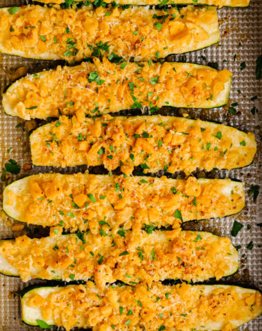 Baked zucchini in a baking dish, covered in a cracker and cheese mixture