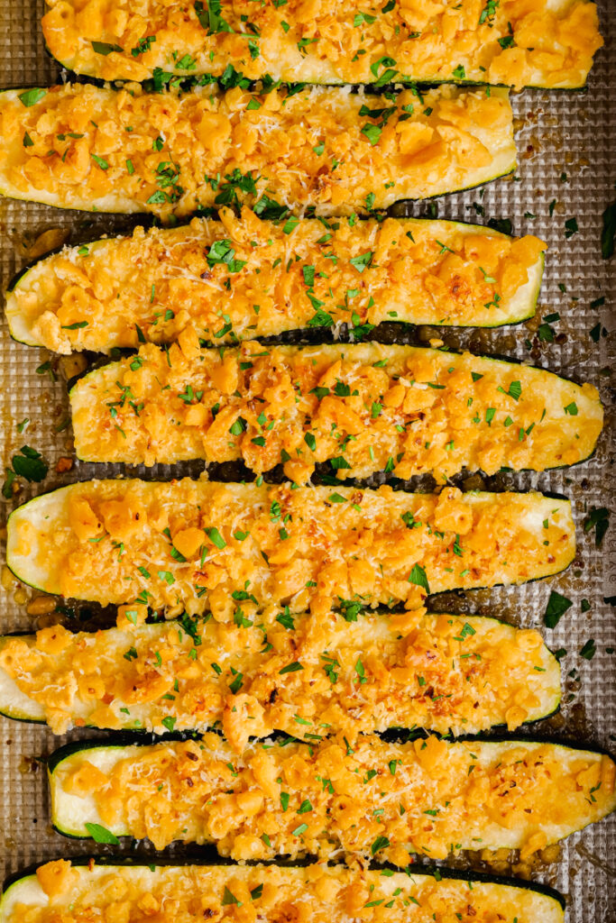 Baked zucchini in a baking dish, covered in a cracker and cheese mixture