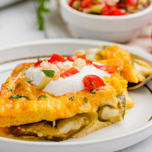 A white plate with chiles rellenos