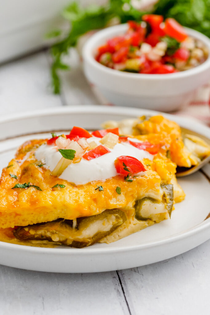 A white plate with chiles rellenos