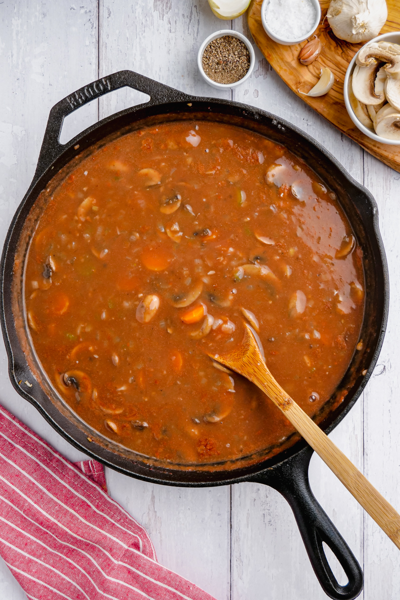 gravy in black skillet, with wooden spoon.