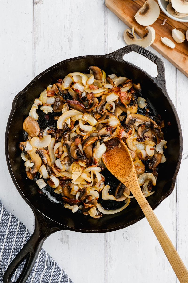 A skillet with all the things you need for smothered pork chops