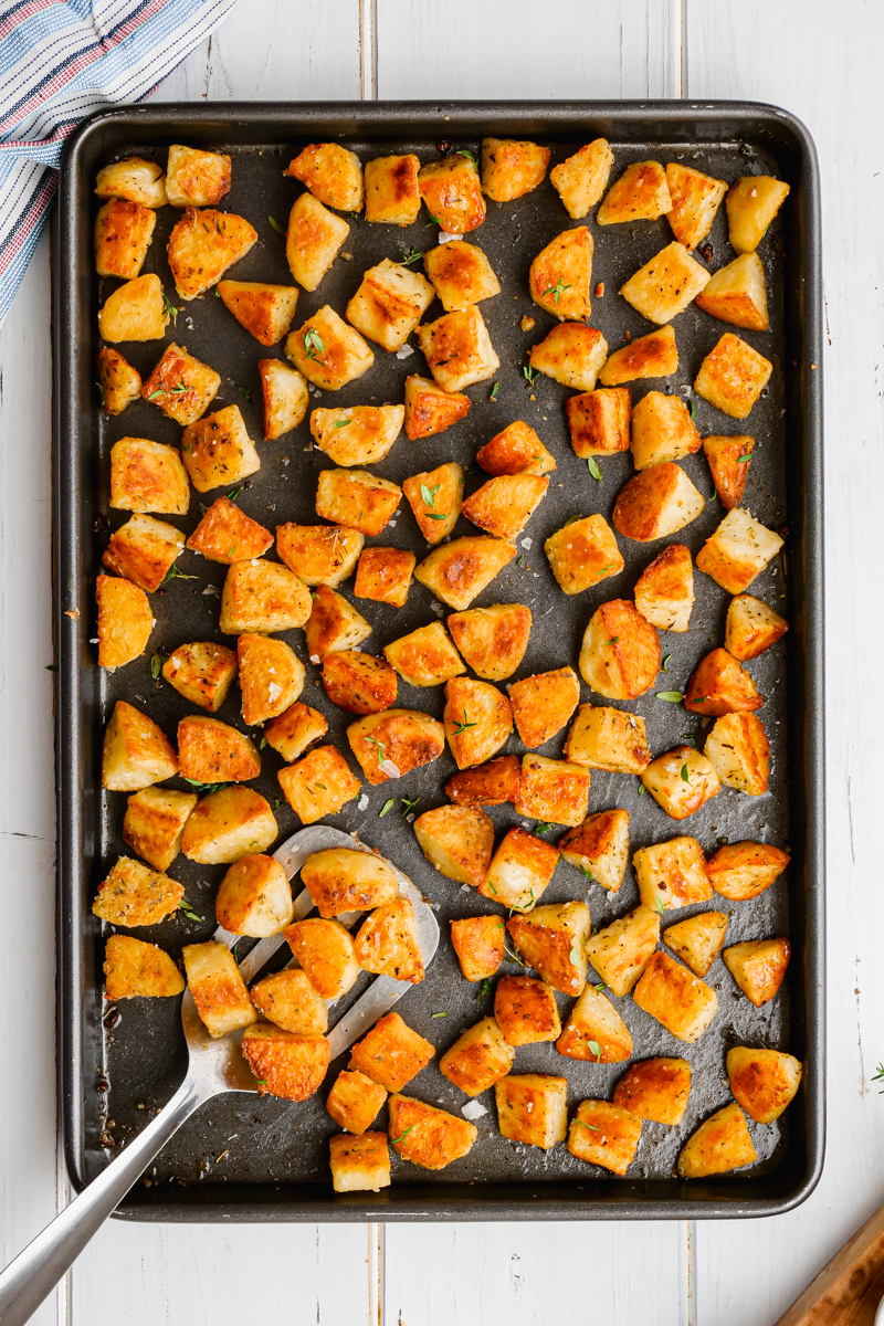 A baking sheet loaded with crispy baked potatoes