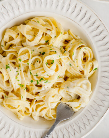 A white plate of fettuccine alfredo