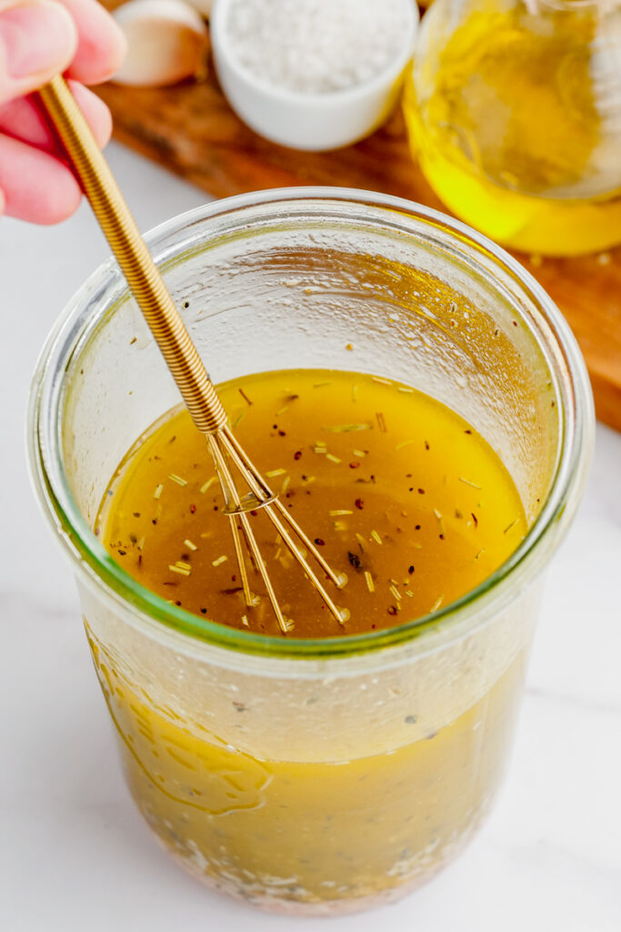 Italian Pasta Salad in a jar tin all ingredients being shaken together.