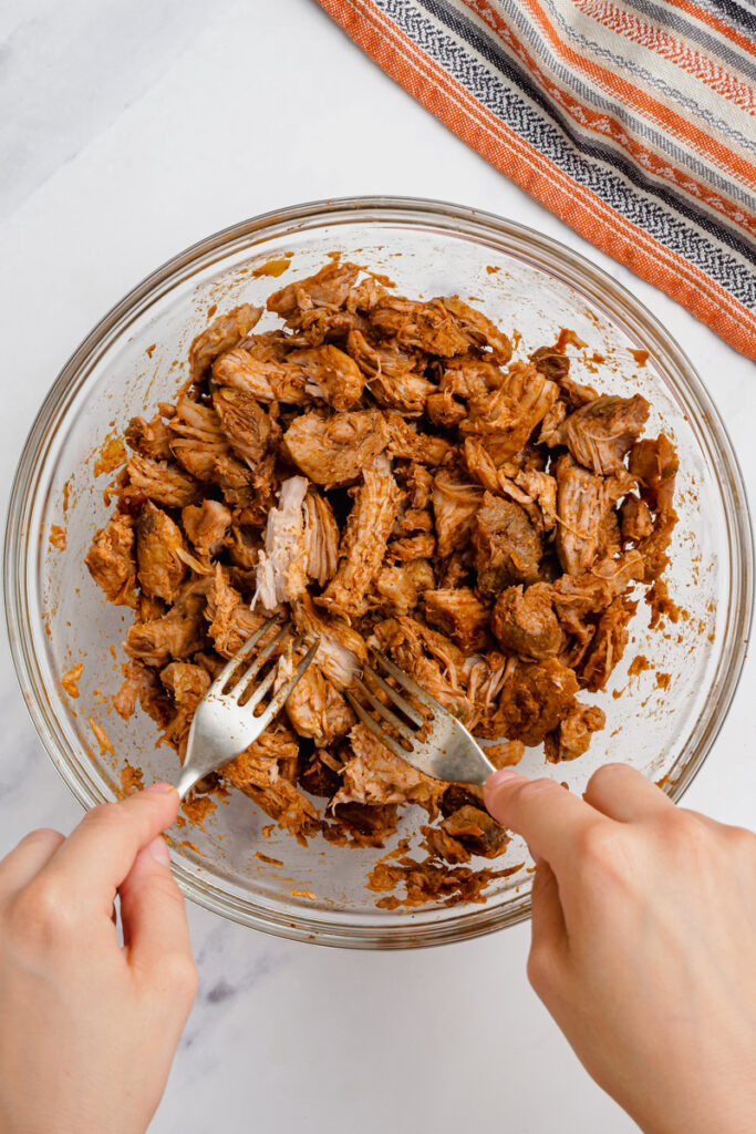 shredding pork for pork mole tacos