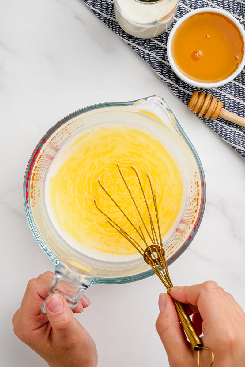 Whisking wet ingredients for sandwich bread together.