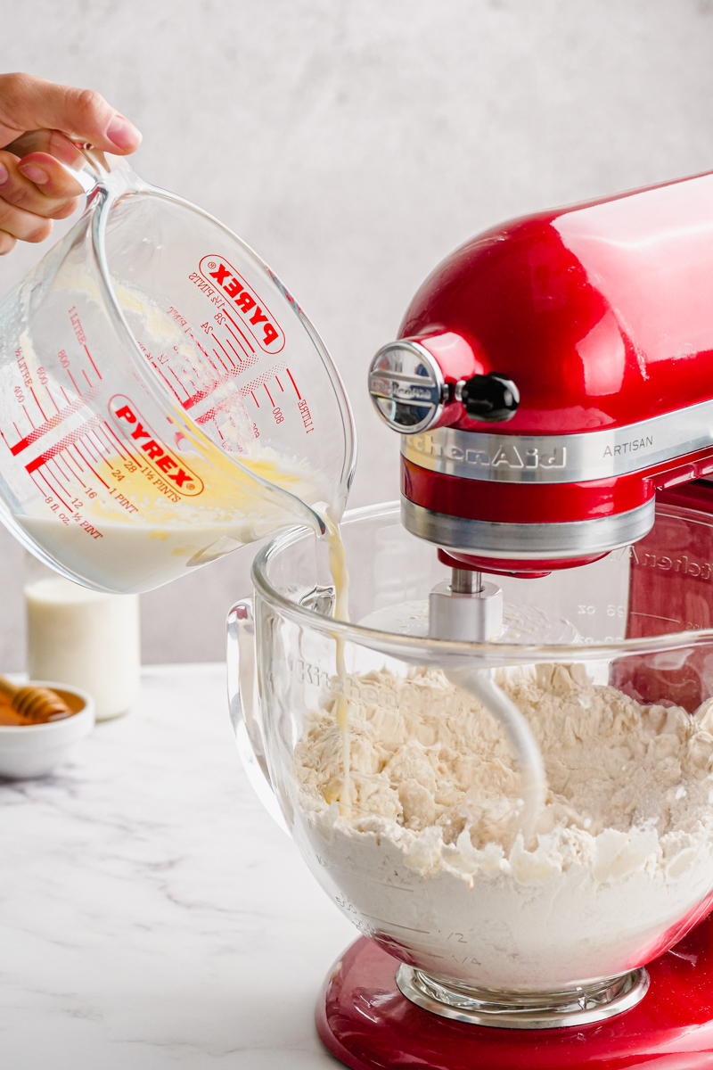 Combining wet and dry ingredients in a stand mixer.