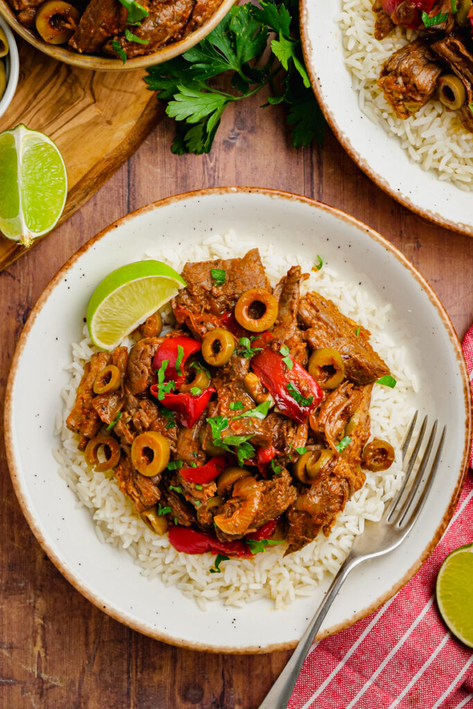 A white plate topped with ropa vieja