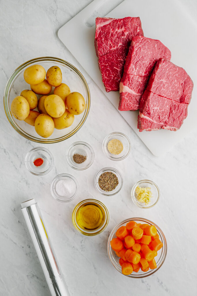 steak and potato ingredients on cutting board