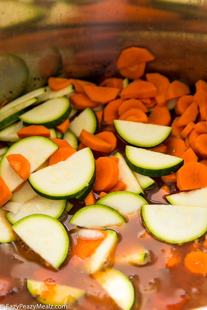 Adding fresh vegetables to minestrone soup